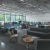 A spacious modern office with desks, computers, and natural light creating an inviting work environment.