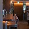 A stylish and cozy bar interior with ambient lighting and modern design elements.