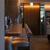A stylish and cozy bar interior with ambient lighting and modern design elements.