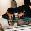 Father and son examining an exhibit in a museum in Nanjing, China, capturing an educational moment.